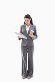 Businesswoman with a coffee reading a newspaper