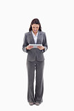 Businesswoman smiling watching a touch pad
