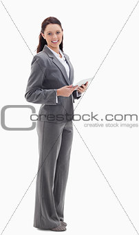 Profile of a businesswoman smiling with a touch pad