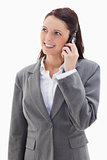 Businesswoman looking up while smiling on the phone