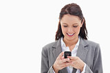 Close-up of a businesswoman smiling and writing a text message