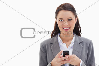 Businesswoman smiling and holding her mobile