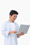 Smiling male on his laptop
