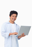 Smiling male with his laptop