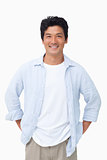 Smiling man with hands in his pockets