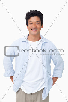 Smiling man with hands in his pockets