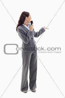 Businesswoman announcer speaking in a microphone 
