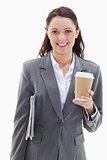 Businesswoman smiling with a newspaper and coffee