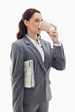 Businesswoman with a newspaper drinking a coffee