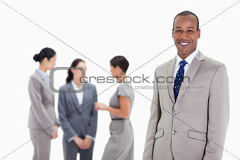 Businessman with co-workers talking in the background