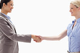 Close-up of women shaking hands