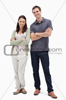 Smiling couple crossing their arms