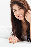Close up of woman looking slighty to the side while smiling with