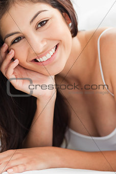Close up Woman with a hand on her cheek, smiling and looking str