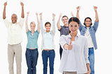 Close-up of a girl with people raising their arms and with their