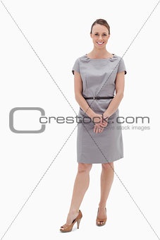 Smiling woman standing up and holding her hands