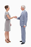 White hair man face to face with a woman and shaking hands