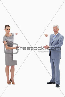White hair businessman holding and pointing to a big white sign 