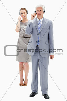 White hair businessman with a woman talking in background while 