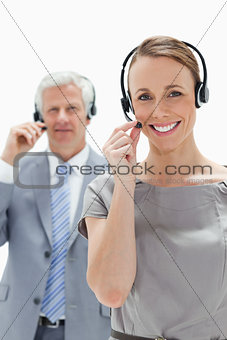Smiling woman wearing a headset with a man