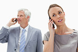 Close-up of a woman on the phone with a white hair businessman