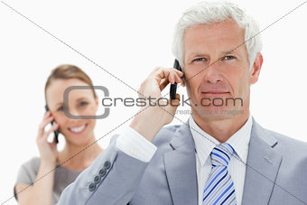 Close-up of a white hair businessman on the phone with a smiling