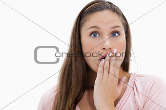 Shocked girl with her hand over her mouth