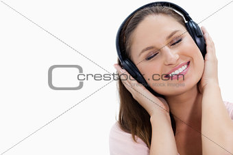 Close-up of a smiling girl listening to music 