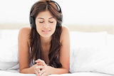 Woman with her eyes closed listening to and enjoying the music o