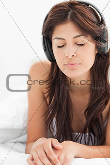 Close up, woman listening to her headphones with her eyes closed