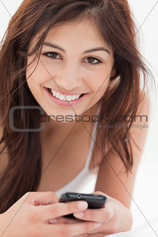 Close up, Smiling woman with her smartphone in hand