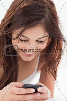 Close up, woman using her smartphone and smiling