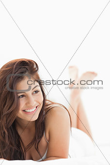 Close up, woman with legs crossed while smiling and looking to t