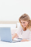 Close up, Woman using laptop on the bed while looking at the scr