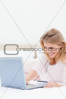 Close up, Woman using laptop on the bed while looking at the scr