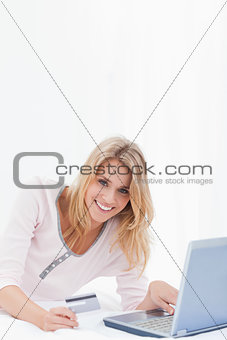 Woman looking forward and smiling as she orders online