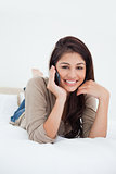 Close up, woman making a phonecall on the bed and smiling as she