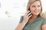 Woman smiling as she makes a call and looks to the side