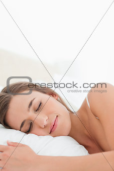 Close up, woman sleeping in bed with her head on the pillow