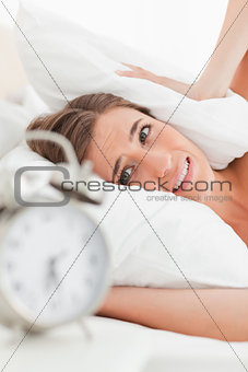 Close up of woman with pillow over her ears