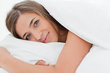 Close up, woman in bed, head on pillow and looking forward