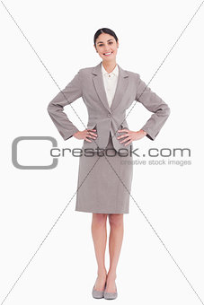 Smiling businesswoman with hands on her hip