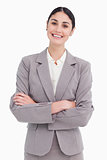 Smiling young saleswoman with arms crossed