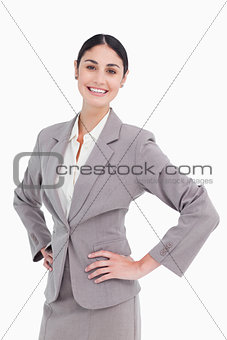 Smiling saleswoman with hands on her hip