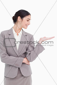 Young businesswoman looking at her palm