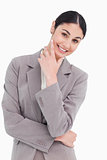 Smiling businesswoman in thinkers pose
