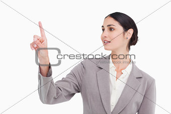 Young saleswoman operating touch screen
