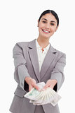 Smiling businesswoman handing over money