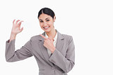 Smiling saleswoman pointing at her business card