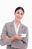 Saleswoman with arms folded and business card